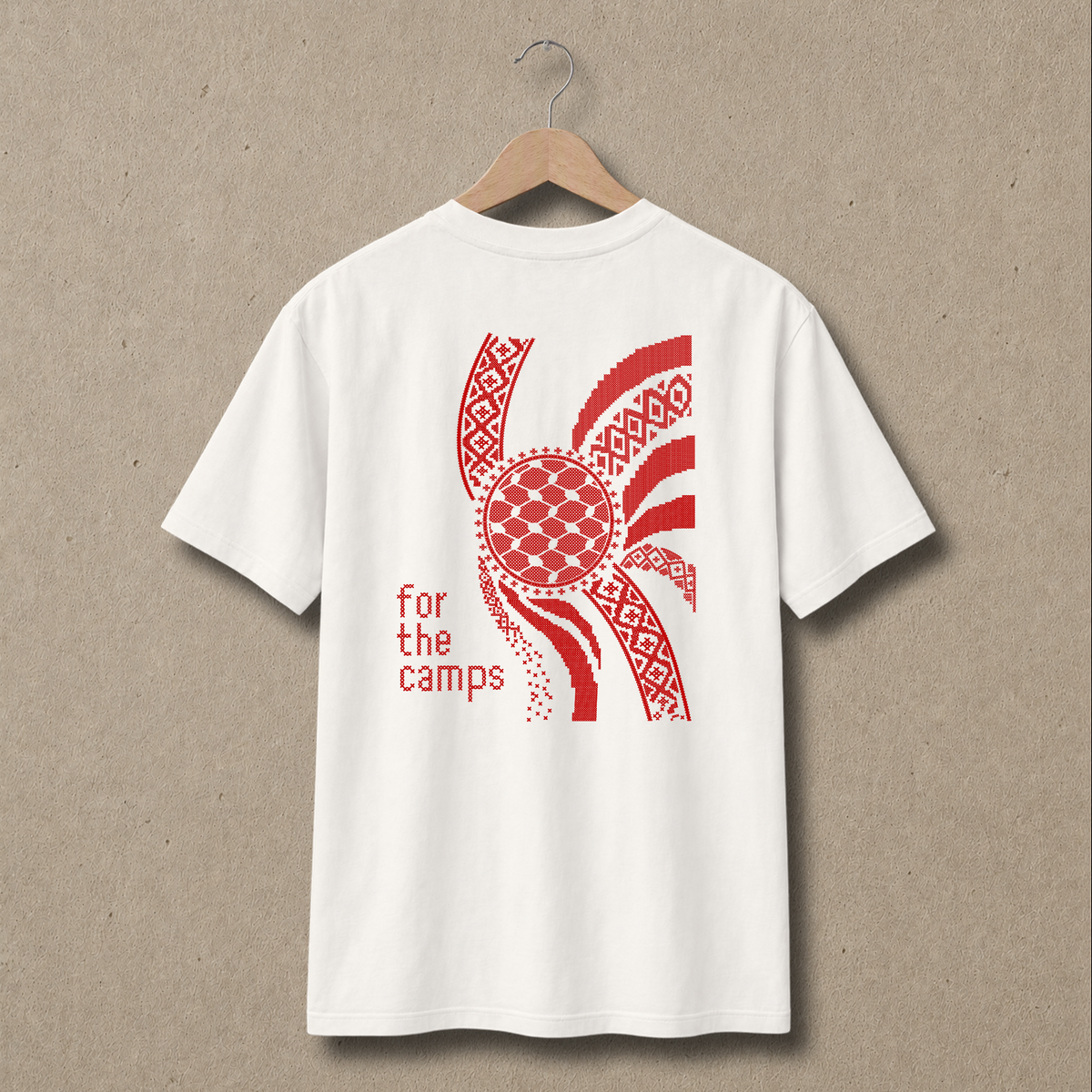 Back view of natural For the Camps Palestinian T-shirt featuring a large red tatreez-inspired graphic, keffiyeh-pattern circle and “for the camps” text.
