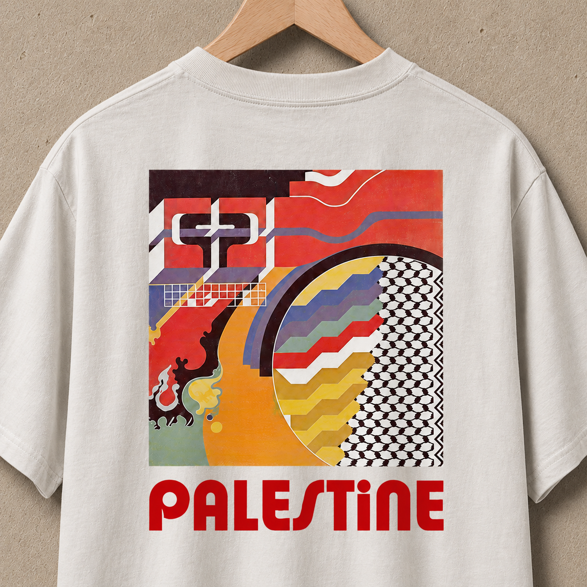 Close-up back view of the heavyweight faded-bone Geometry T-shirt featuring a colorful geometric Palestine graphic with keffiyeh patterning and red “PALESTINE” lettering.