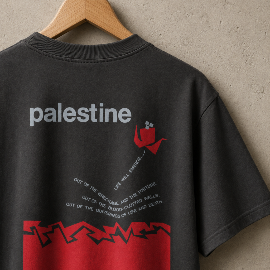 Back view of a faded black heavyweight T-shirt featuring the “Palestine — Life Will Emerge” graphic in gray and red.