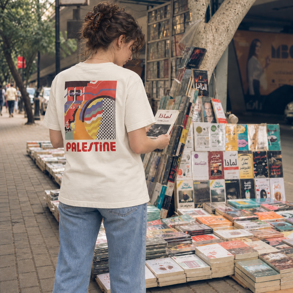 Back view of woman wearing natural Geometry Palestinian T-shirt in an archive with Palestinian Affairs prints and flat-file drawers.